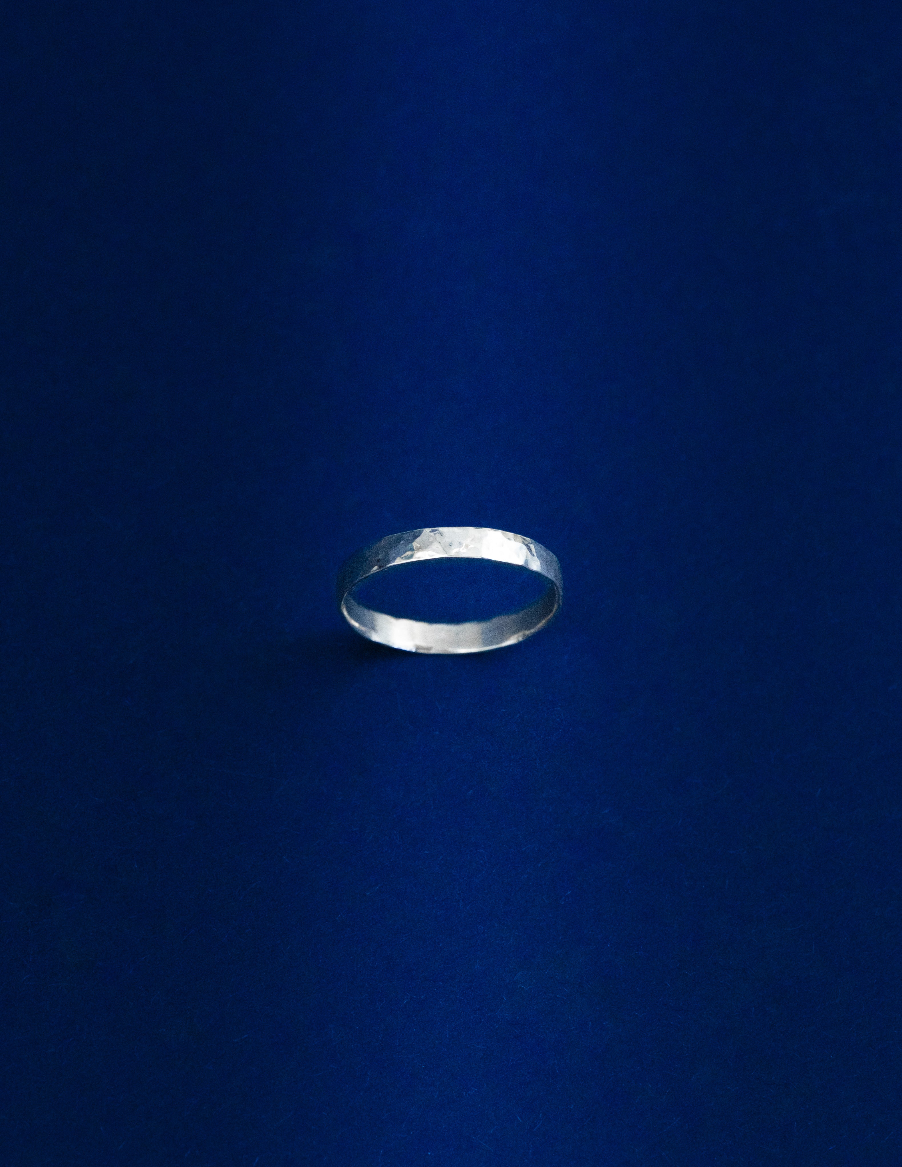 Thicker Silver ring on a dark blue background