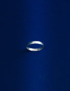 Thicker Silver ring on a dark blue background