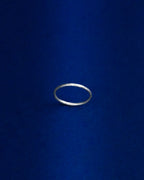 Thin Silver ring on a blue background