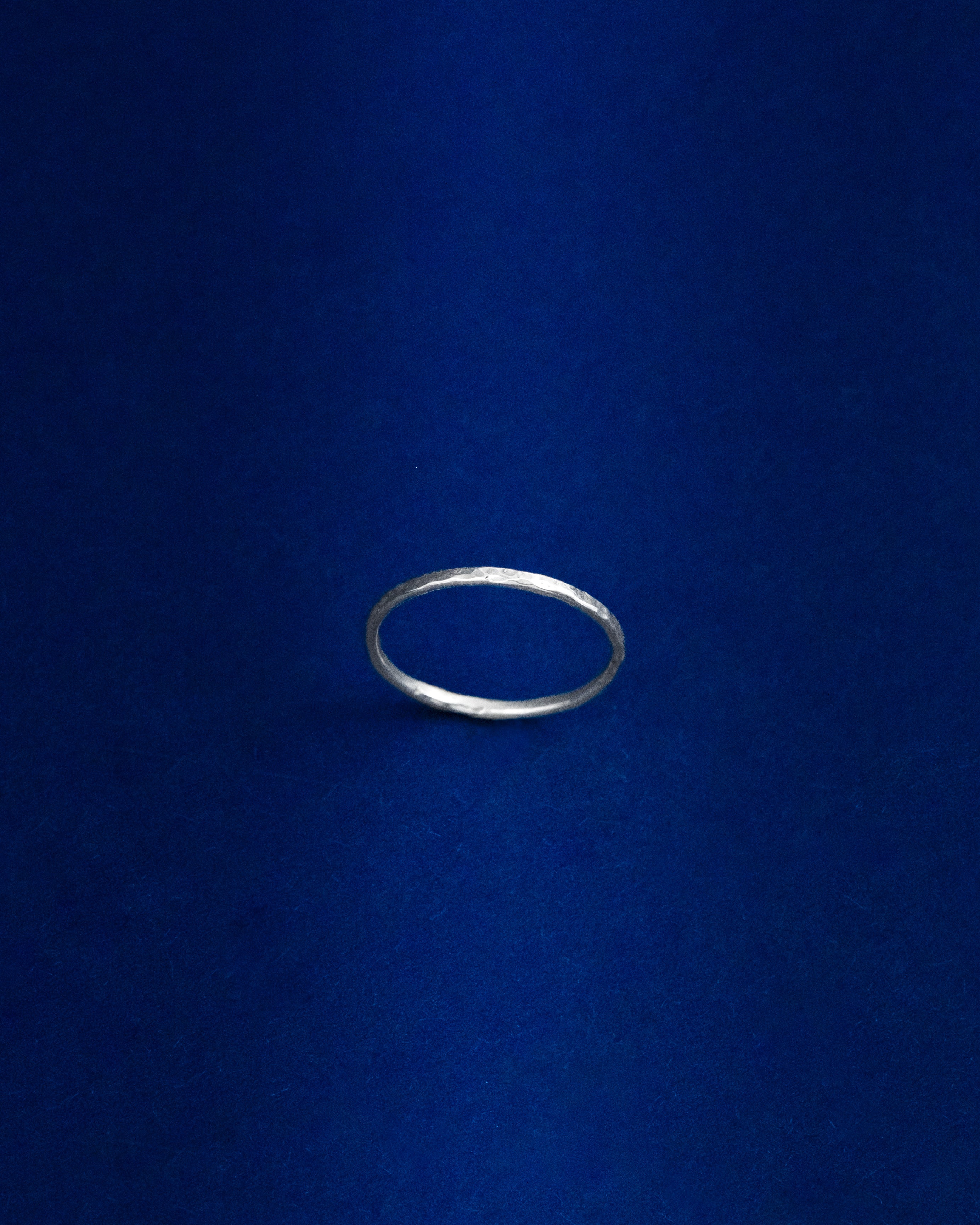 Thin Silver ring on a blue background